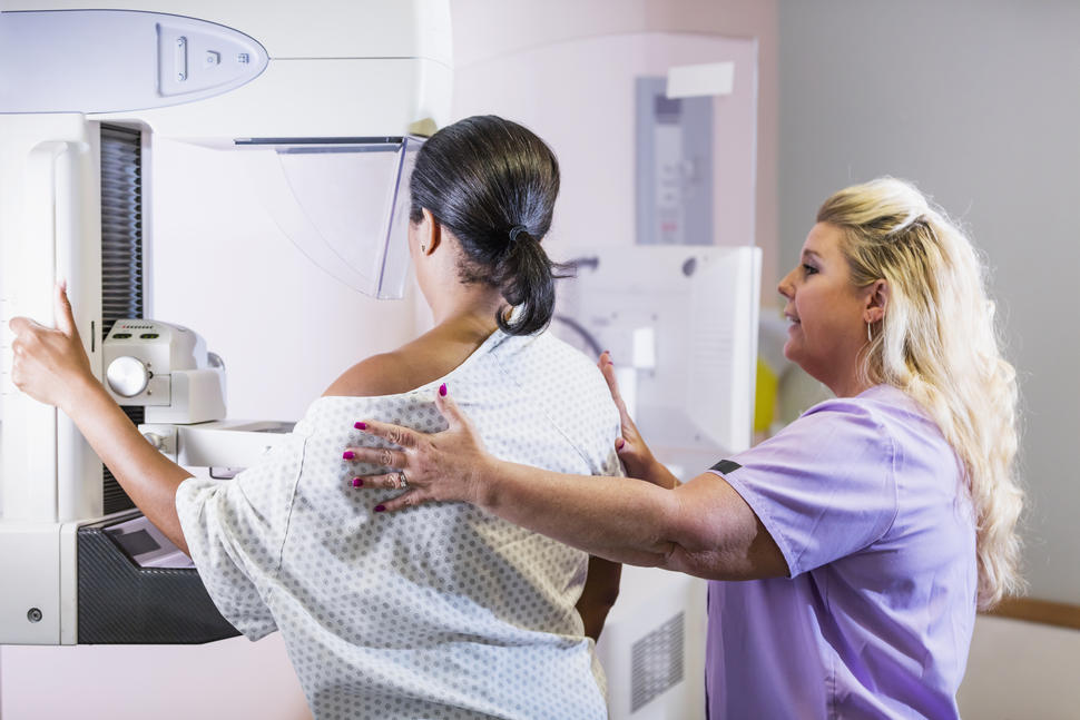 An African American woman undergoing a mammogram