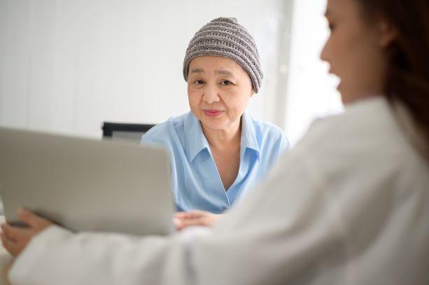 An older female woman wearing a winter cap with female doctor.