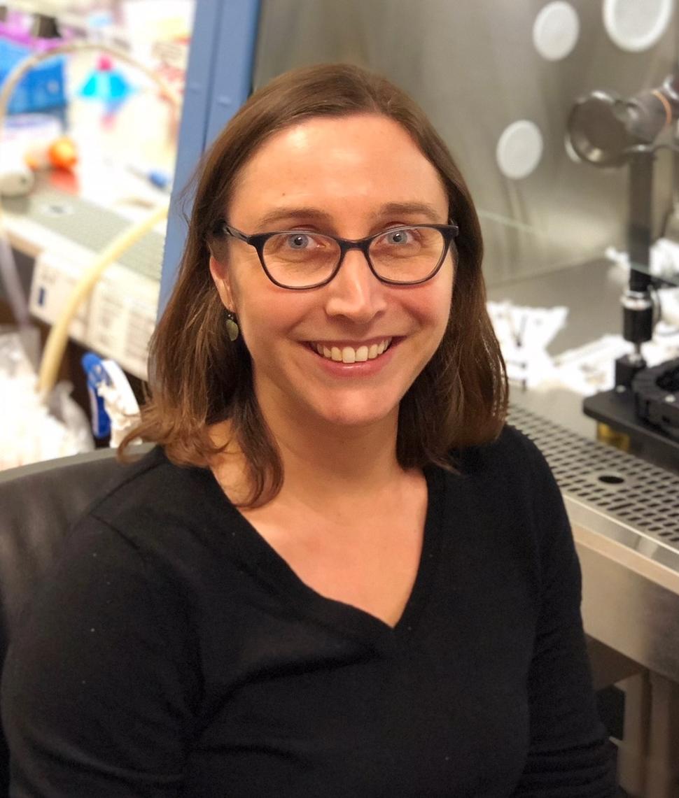 Photo of Dr. Ellen Langer next to a cell culture hood