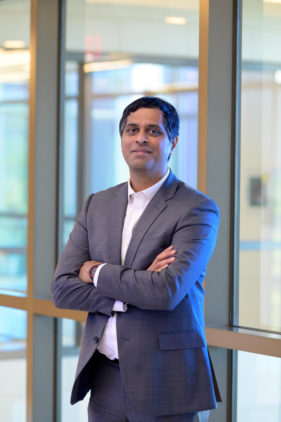 Dr. Satish Gopal standing in front of window