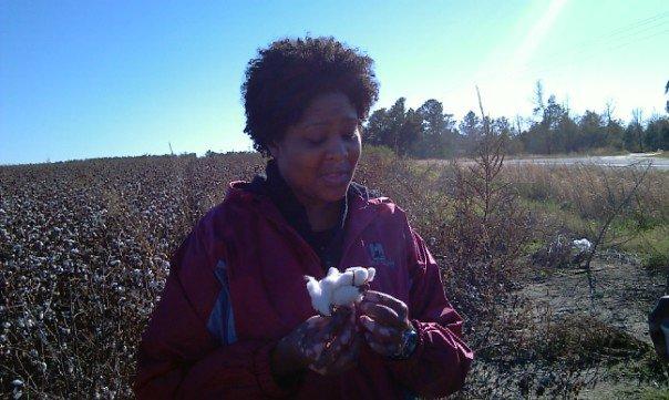 Dr. Melissa Davis standing in a Georgia cotton field. 