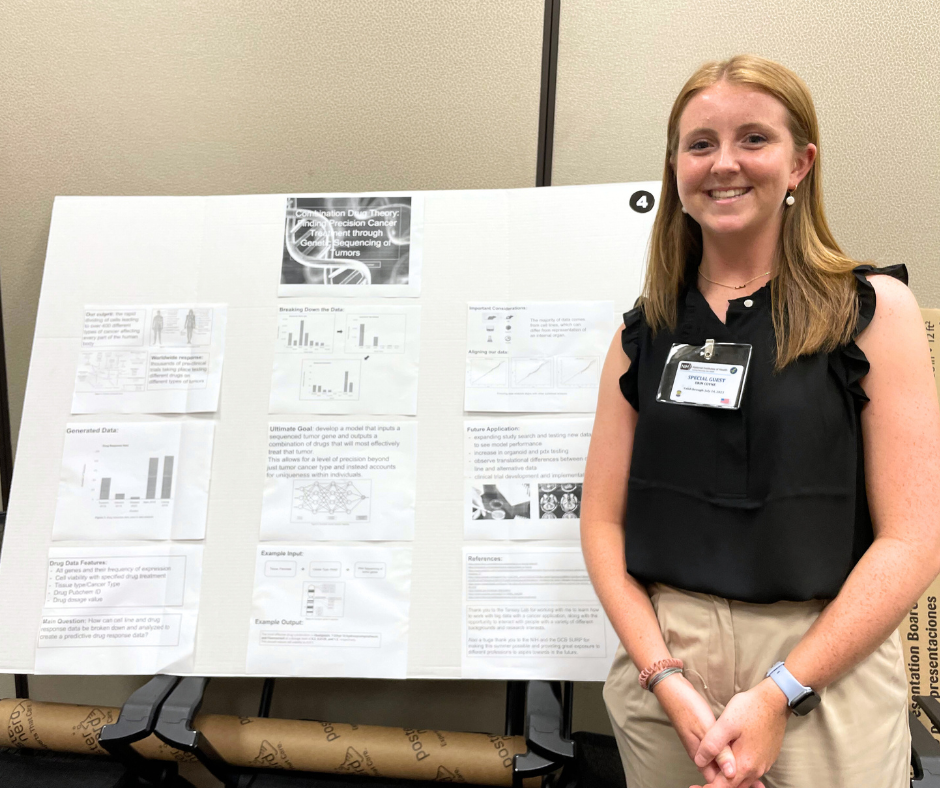 Photo of Erin Coyne presenting a poster at the 2023 NCI Division of Cancer Biology Summer Undergraduate Research Program Conference
