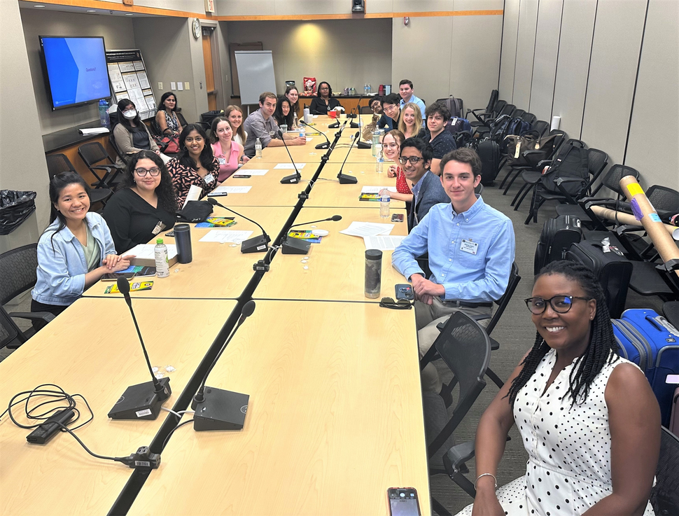 Photo of attendees around the conference table at the 2023 NCI Division of Cancer Biology Summer Undergraduate Research Conference