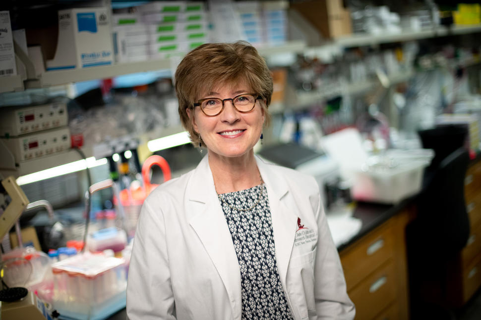 Photo of Dr. Suzanne Baker standing in her laboratory