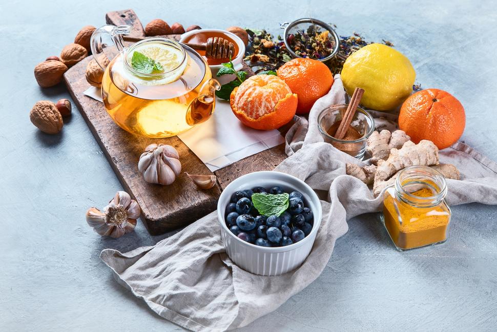 Assortment of healthy fruits, vegetables, and tea.