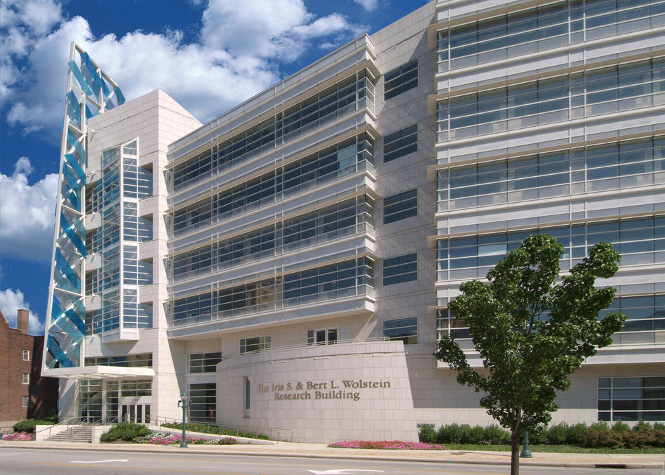 External view of Case Western Reserve University Case Comprehensive Cancer Center, a modern research building with a distinctive architectural design featuring large glass windows and clean white stone.