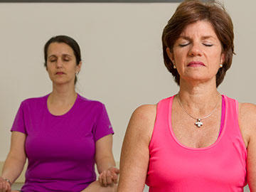 Two women practicing yoga