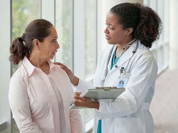 A doctor comforting a patient.