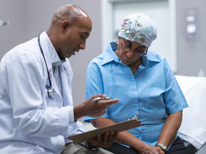 Older African-American woman in consultation with a doctor.