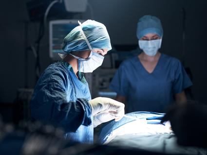 A woman surgeon performing surgery in an operating room