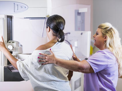 An African American woman undergoing a mammogram