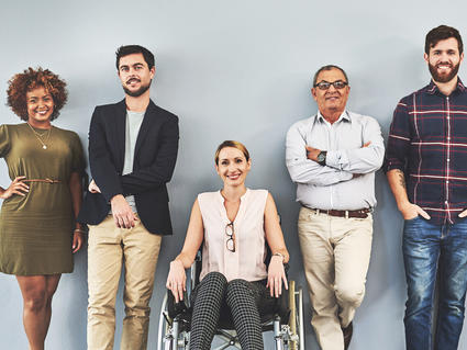 People standing against a wall. 