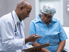 Older African-American woman in consultation with a doctor.