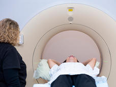 person lying on a table ready to go into an MRI machine