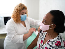 nurse giving someone a shot in the arm