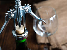 close-up of cork screw and wine glass