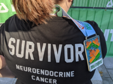 Bethany ross from the back with a "survivor neuroendocrine cancer" shirt