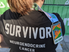 back of black jacket that says survivor in big letters