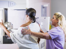 An African American woman undergoing a mammogram