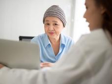 An older female woman wearing a winter cap with female doctor.