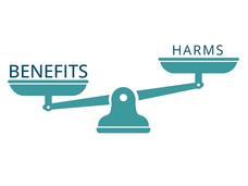 Illustration of a set of scales with the word "benefits" outweighing the word "harms"