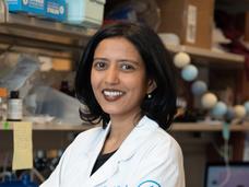 Photo of Dr. Karuna Ganesh standing in her laboratory