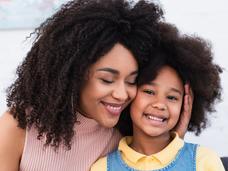 Image of smiling African American mother and child.