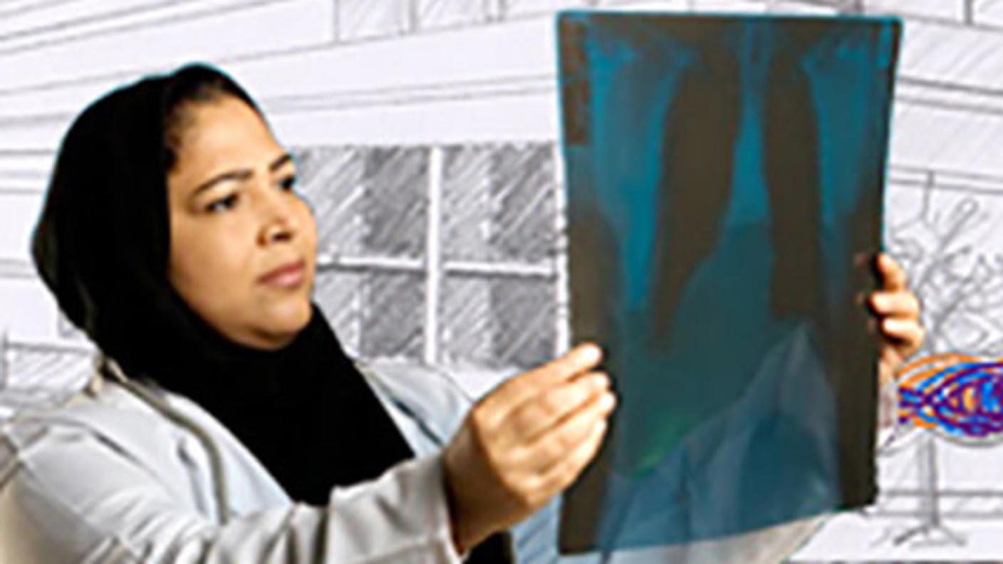 Female researcher holds and studies an x-ray image.