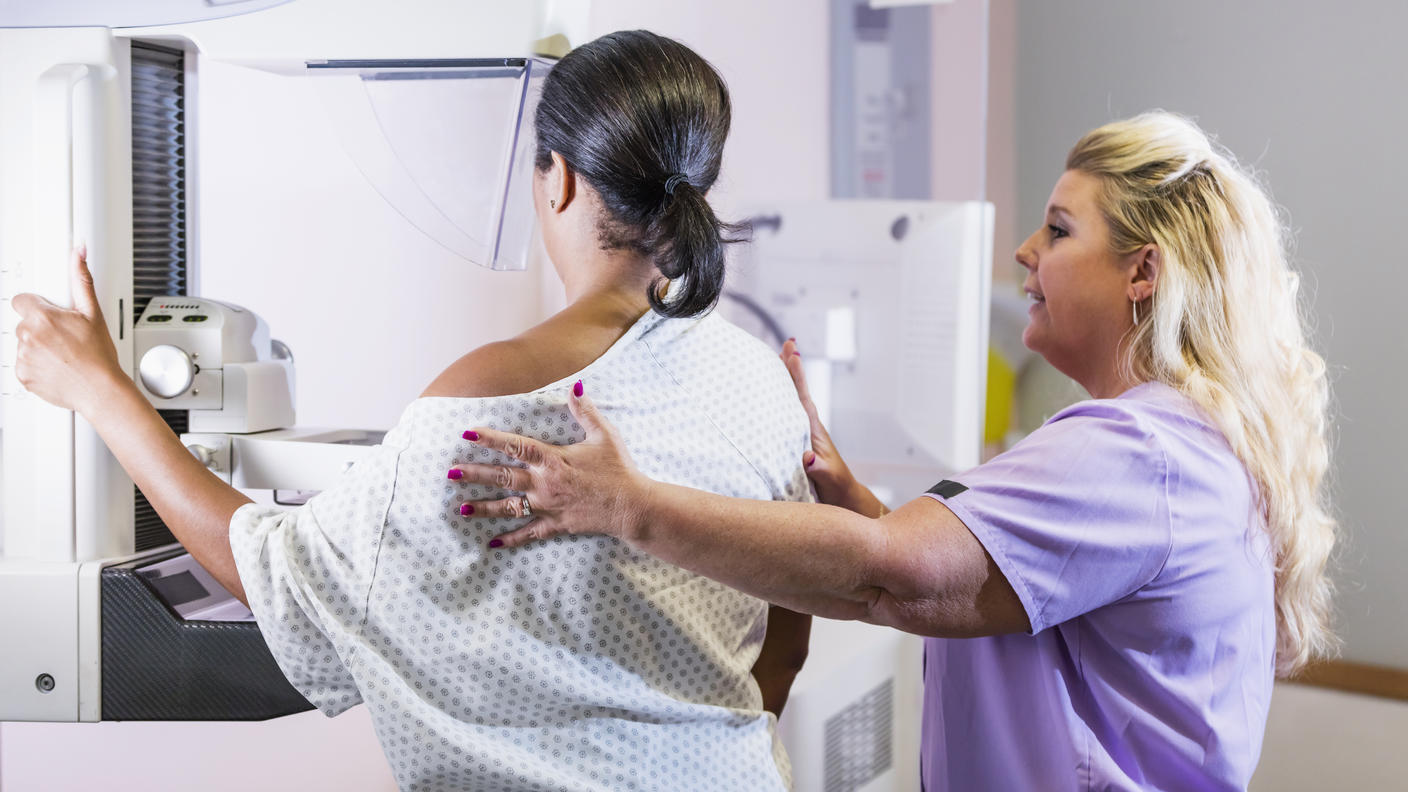 An African American woman undergoing a mammogram