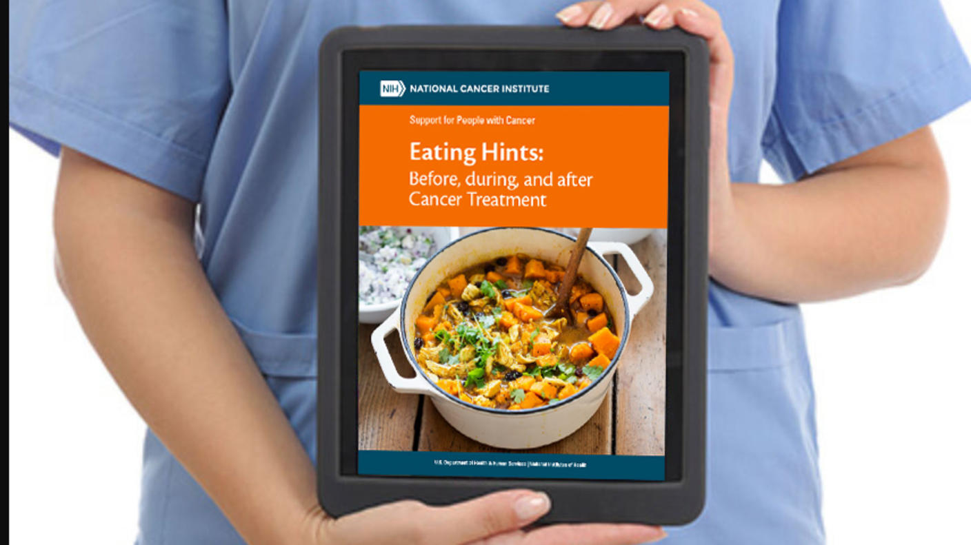 Health professional holds a tablet with NCI's Eating Hints booklet on its screen.