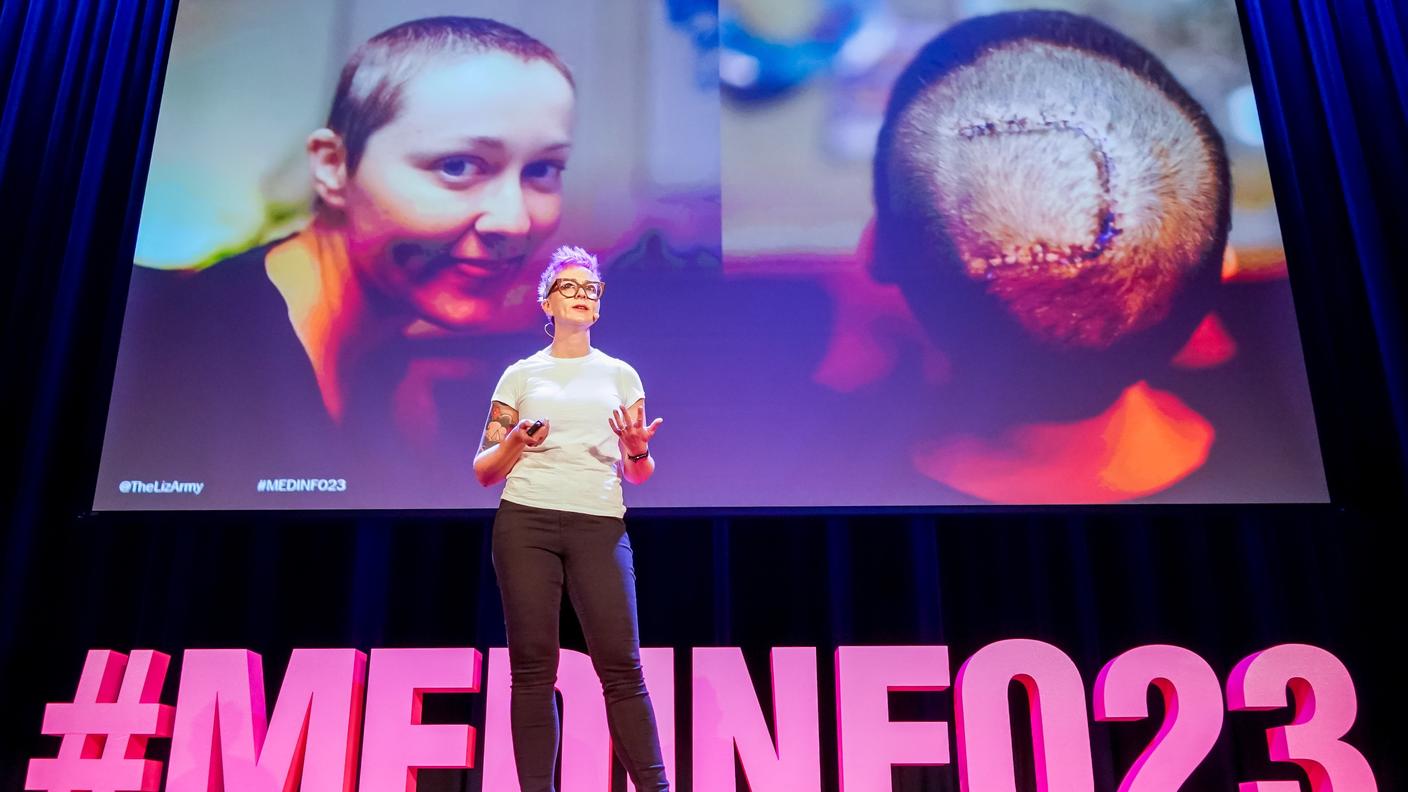 Liz Salmi standing on stage during the MedInfo23 conference