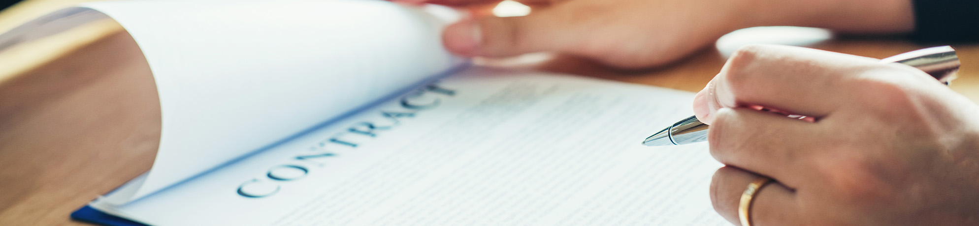 Close-up of a contract being signed