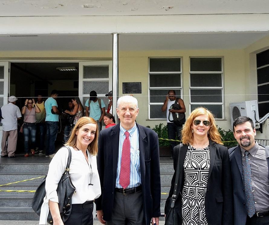 Dr. Clarissa Mathias, Dr. Ted Trimble, Dr. Amy Dubois and and Doug Perin stand together for a photo, smiling at the camera outside of the Aristides Maltez Hospital in Salvador