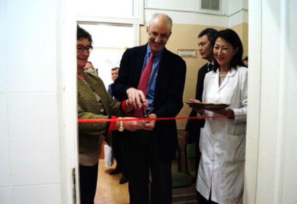Ted Trimble cutting a ribbon at an opening ceremony.