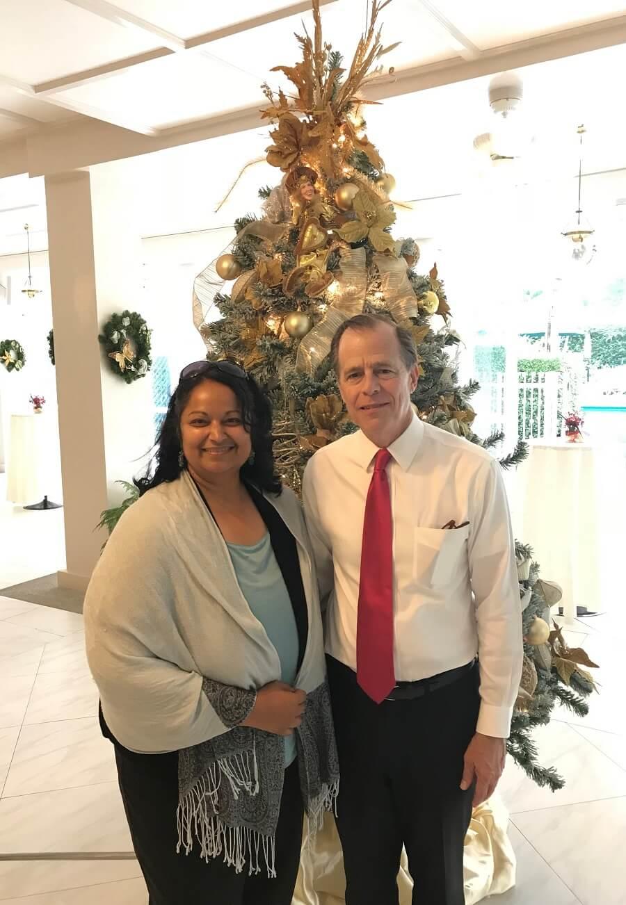 An attendee standing with the American ambassador, Glyn T. Davies.