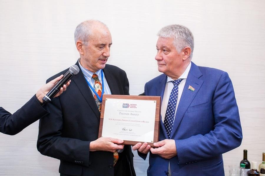 Dr. Ted Trimble delivering the CGH Partner Award to Dr. Oleg Sukonko.