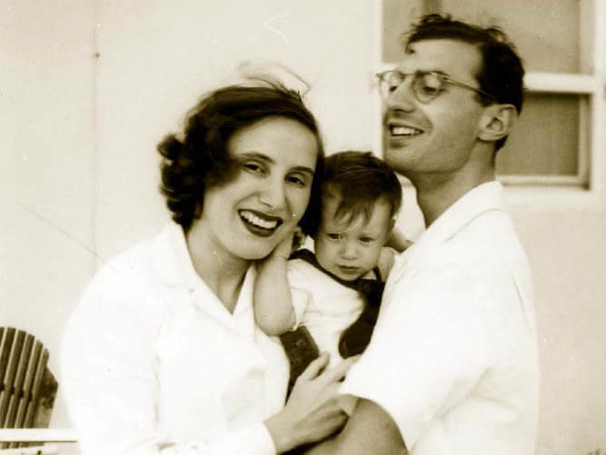 Vintage black-and-white photo of Dr. Alan Rabson with his wife, Dr. Ruth Kirschstein who are both holding their baby son, Arnold.