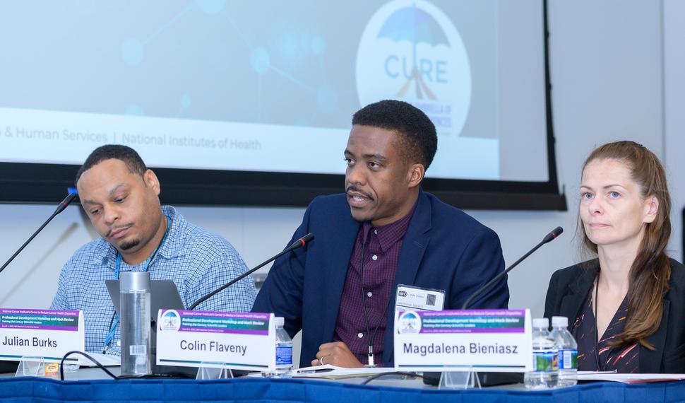 Dr. Colin Flaveny addressing a mock review panel. 