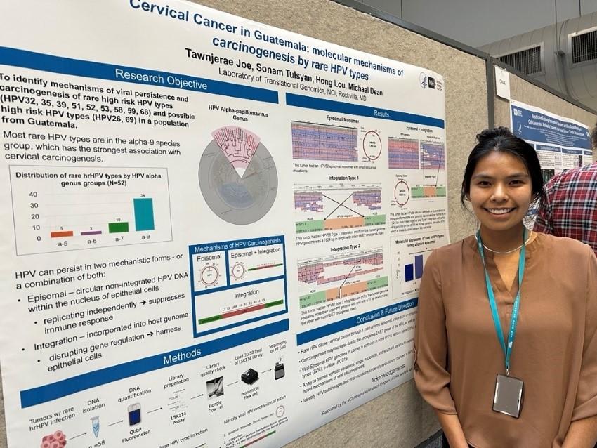 Student standing alongside her poster at 2025 NIH Research Festival.