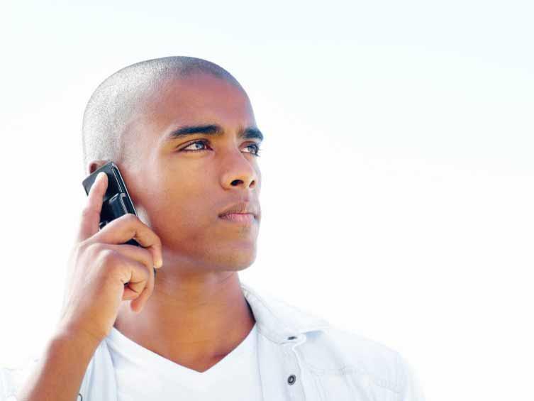 Male holding a cell phone to his ear.