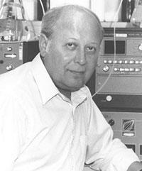 Black and white photo of Barnett Rosenberg, Ph.D with scientific equipment in the background.