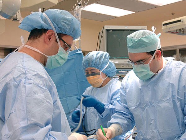 Group of surgeons in caps and masks.