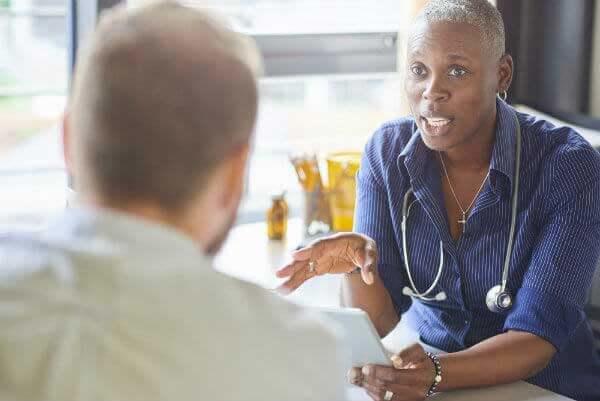 A female doctor speaking with a male patient.
