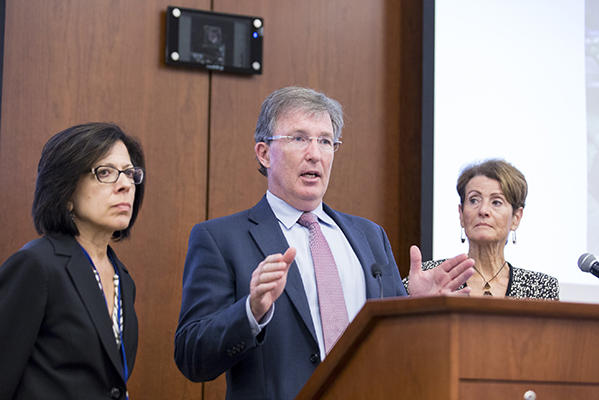 The co-chairs of the Blue Ribbon Panel stand before a lectern