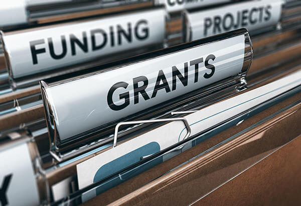 Photo of a file cabinet with Grants, Funding and Project folders