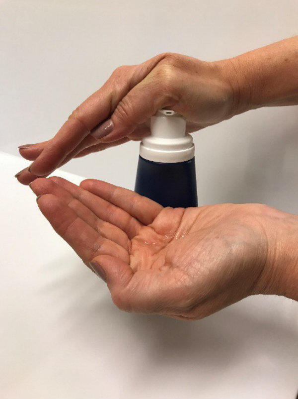 A woman pumping gel into her hands