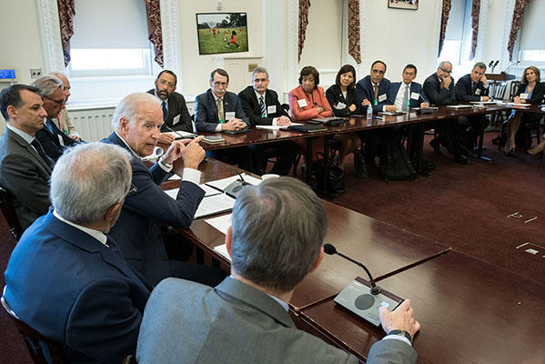 VP Biden speaks to panelists who sit at tables