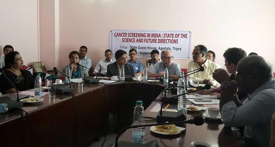 A group of people sitting at a conference table.