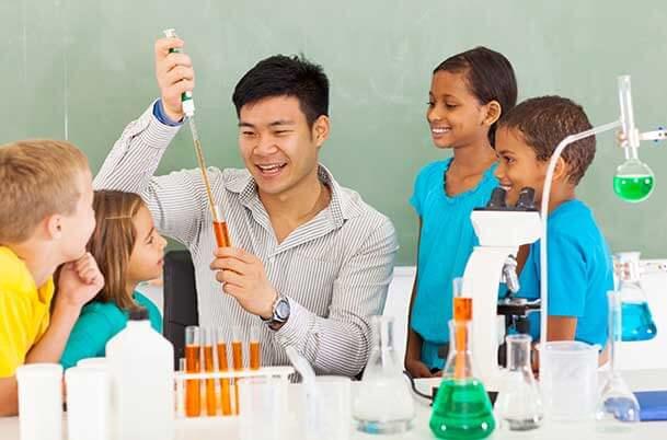 A science teacher demonstrates an experiment to young students