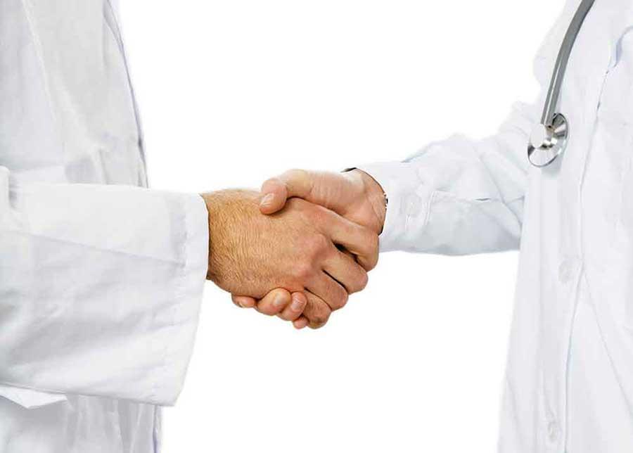 Medical professionals shaking hands.